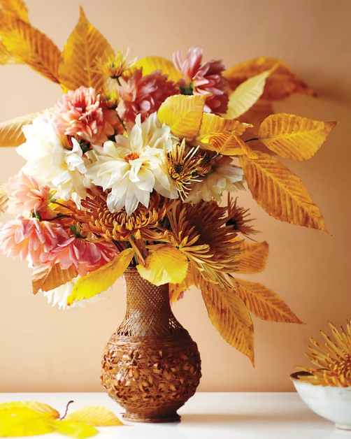 Fall flower arrangements features beech leaves