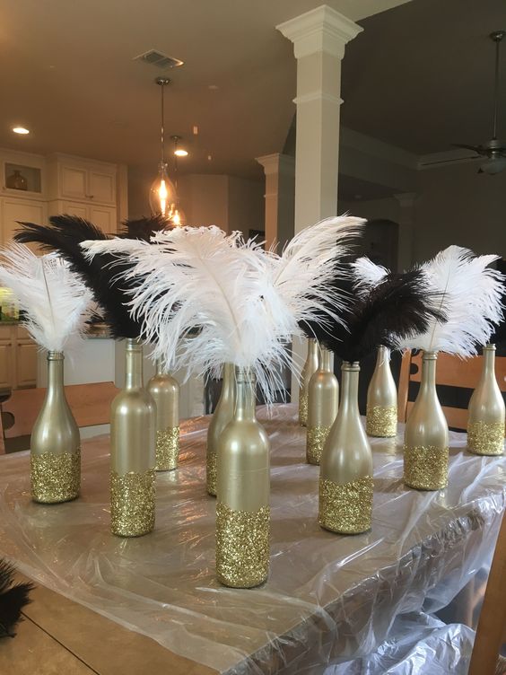 new year's eve centerpieces gold bottles and feathers